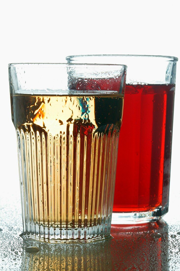 Cranberry juice and apple schorle in glasses