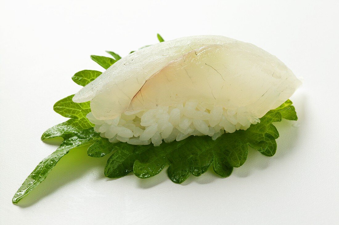 Nigiri sushi with monkfish fillet and shiso leaf