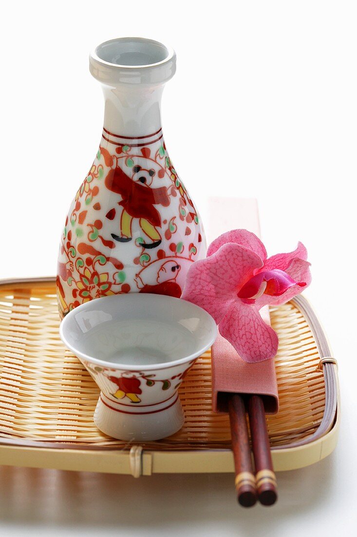 Asian carafe and bowls on bamboo tray