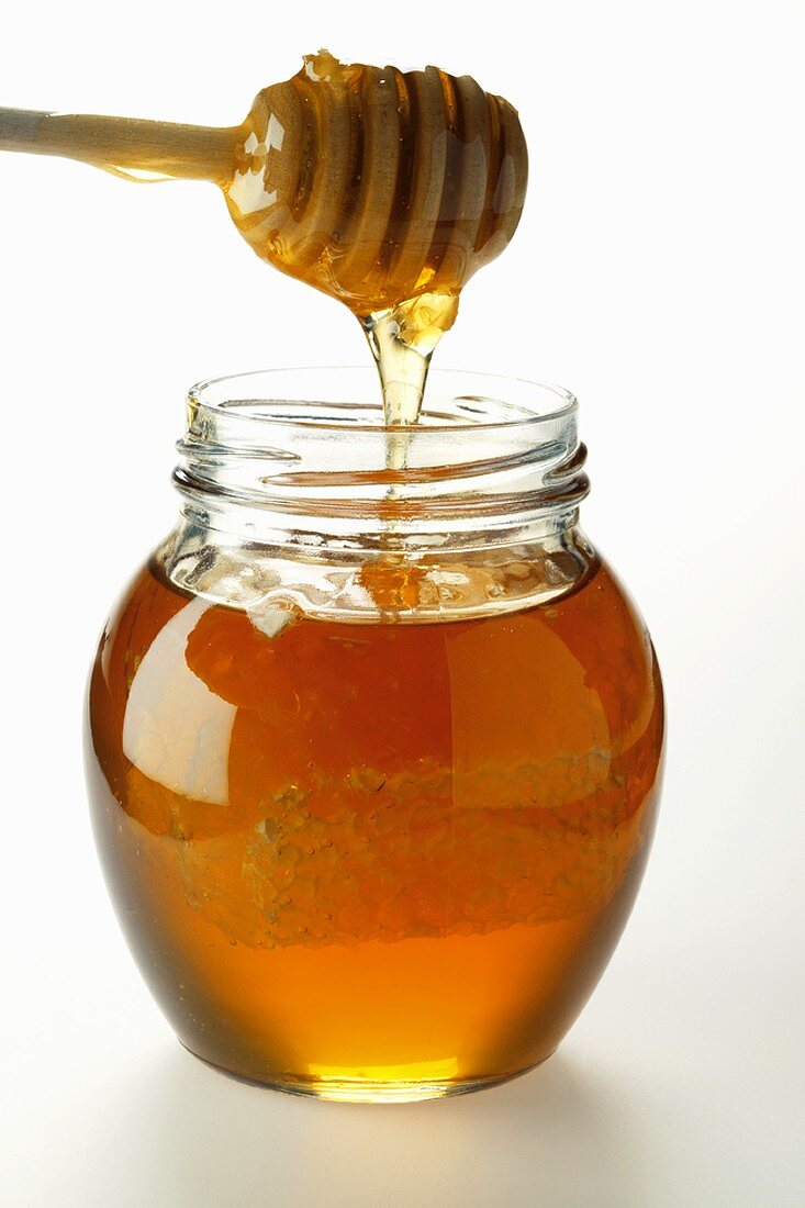 Honey in jar with honeycomb