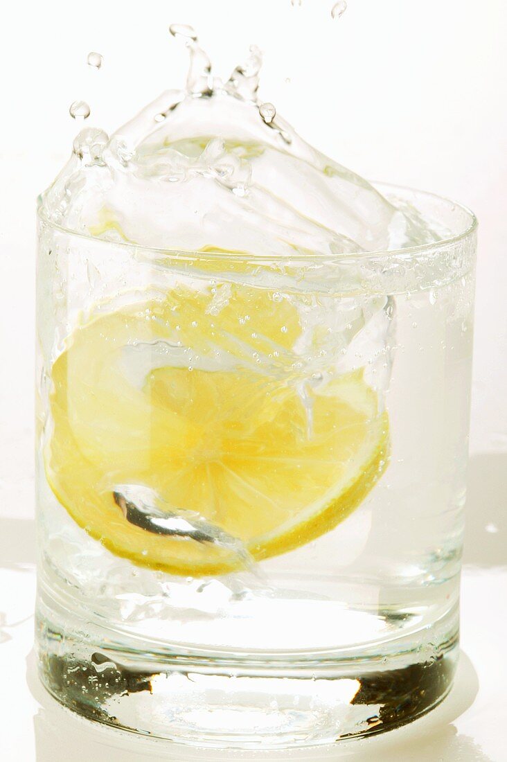 Slice of lemon falling into a drink