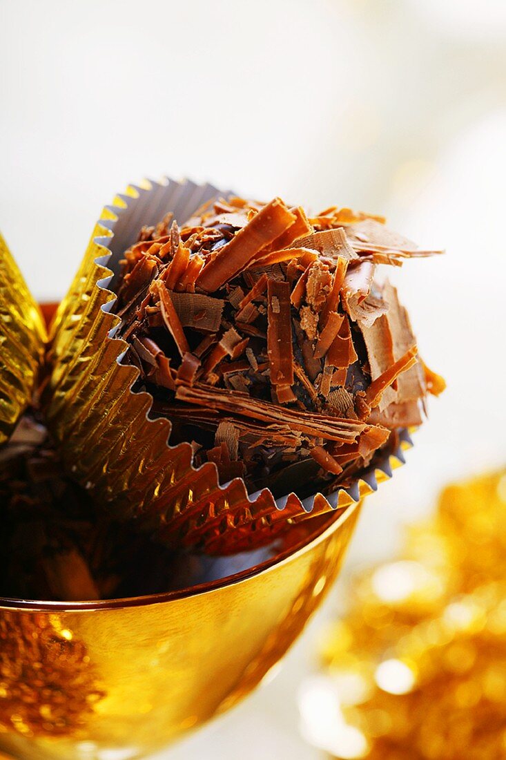 Chocolate truffles in golden bowl