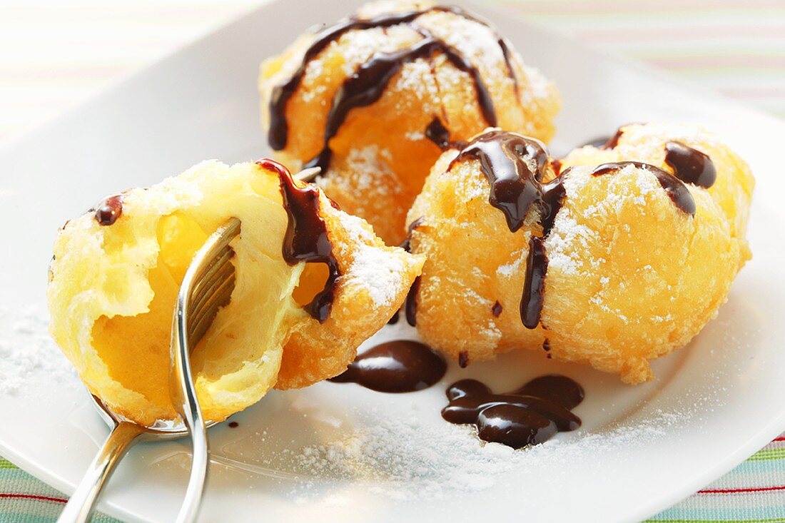 Chocolate doughnuts with icing sugar