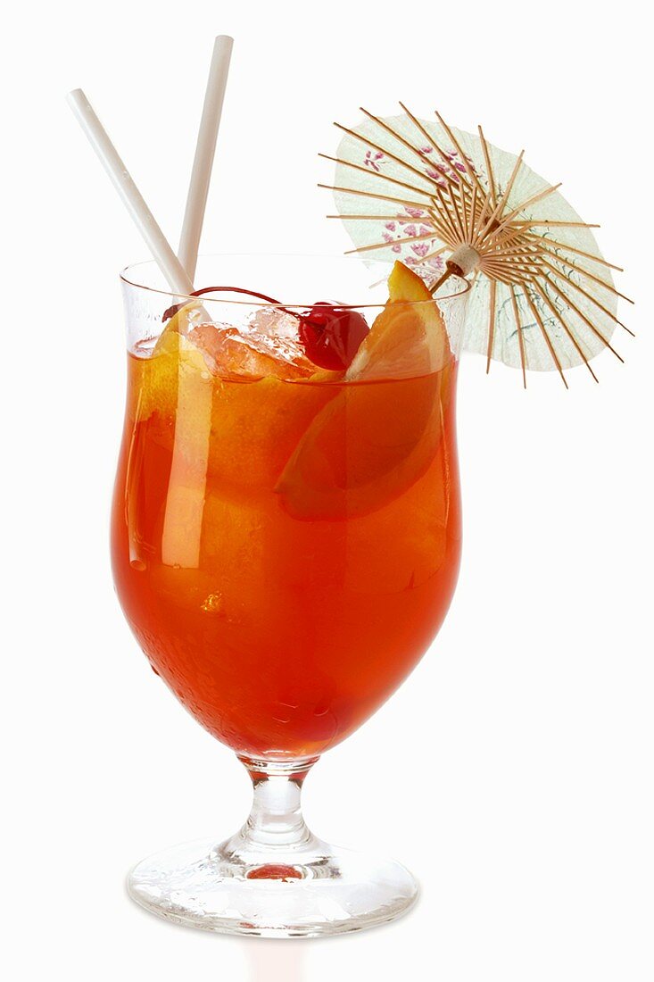 Fruit cocktail in cocktail glass with straws and parasol