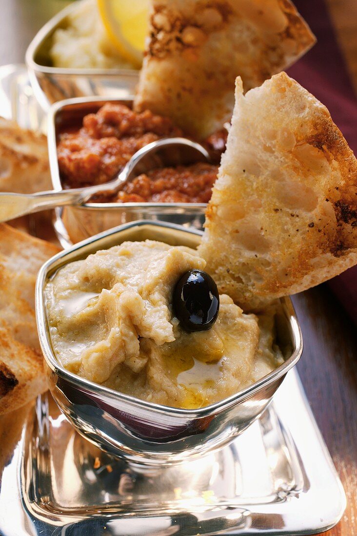 Three spicy dips with toasted white bread