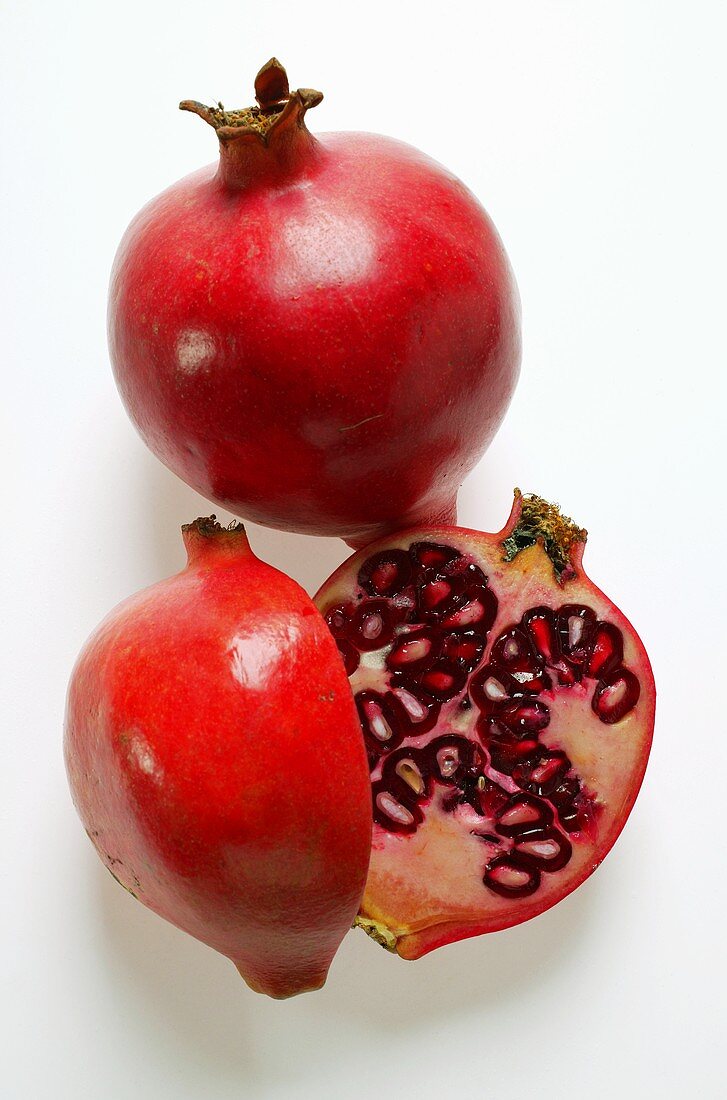 Whole and halved pomegranate