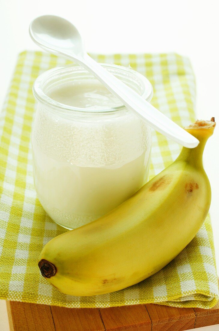 Jar of yoghurt and fresh banana