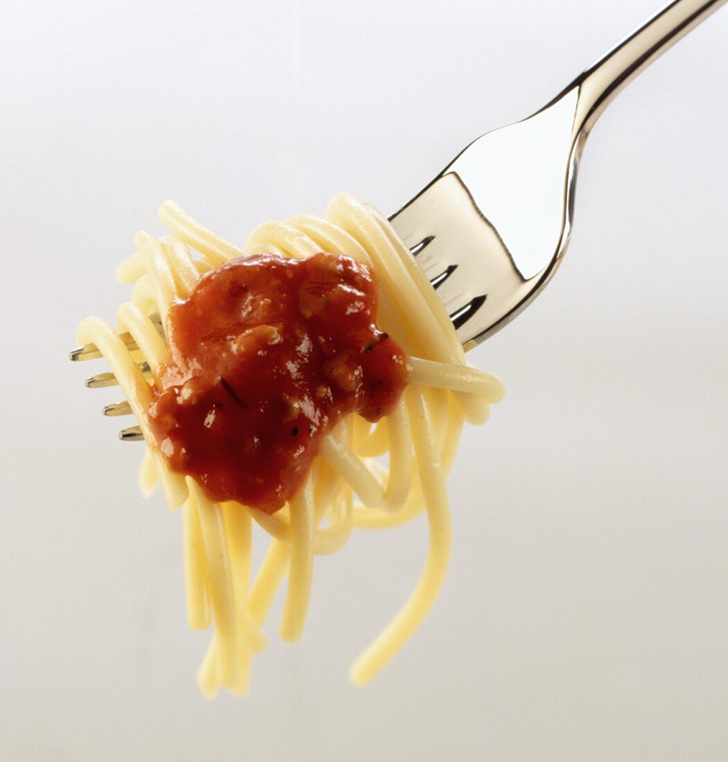 A forkful of spaghetti with tomato sauce