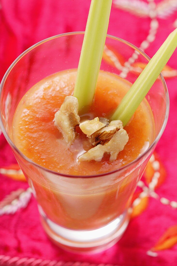 Carrot and mango juice with walnuts and celery