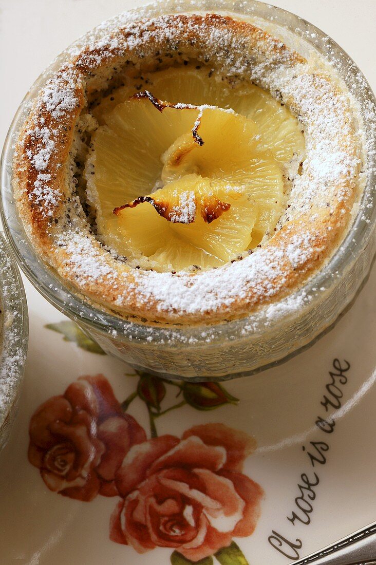 Pineapple and poppy seed soufflé in small glass dish