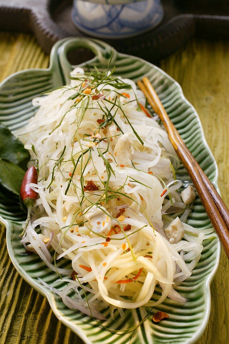 Salad of green papaya with strips of chili pepper