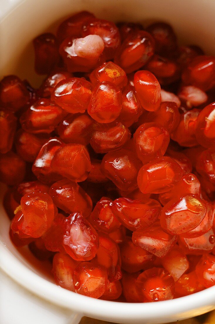 Pomegranate seeds in small bowl