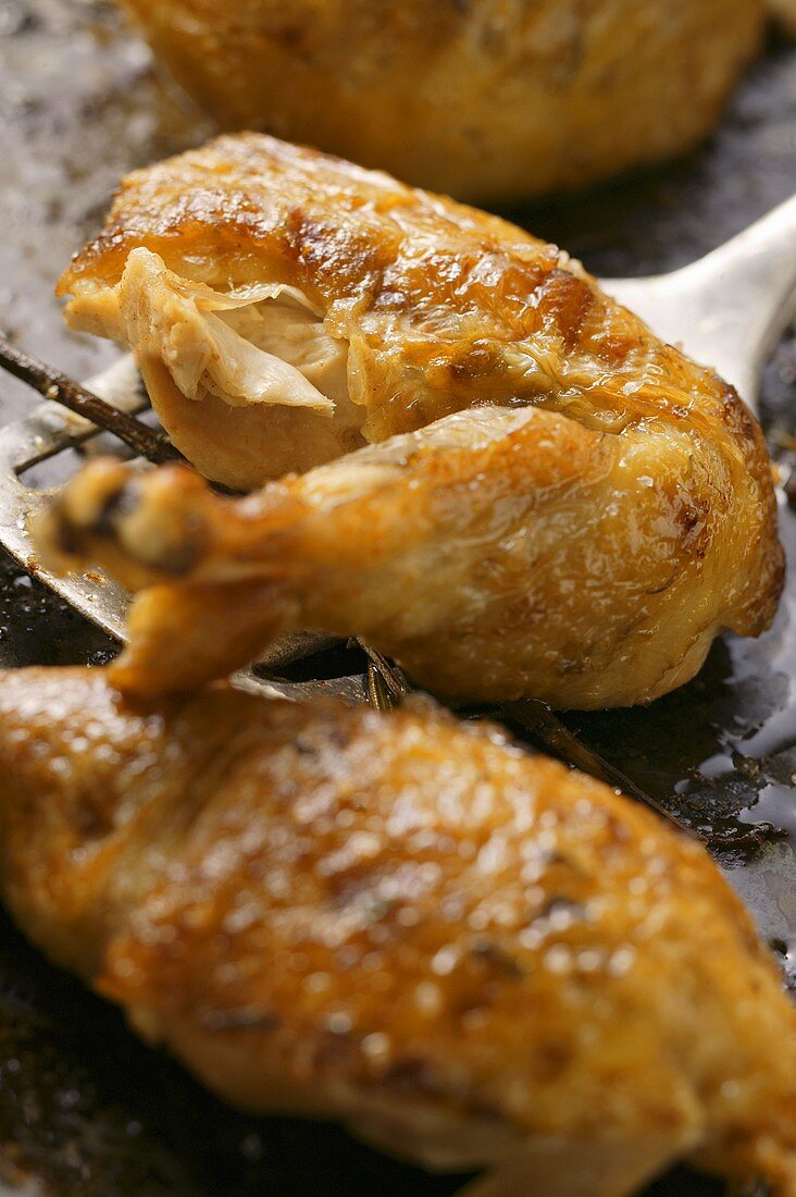 Crispy roast chicken legs on baking tray