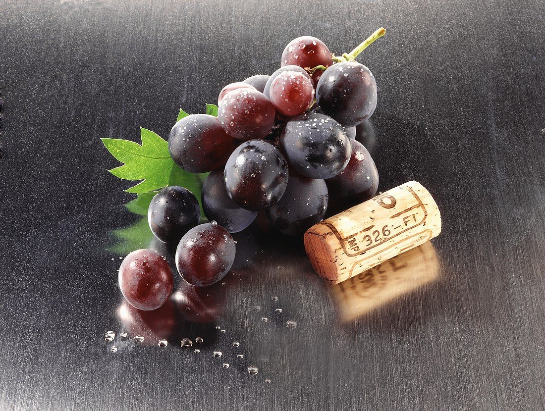 Wine cork and red grapes
