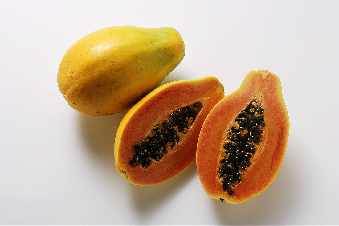 Whole and half papayas