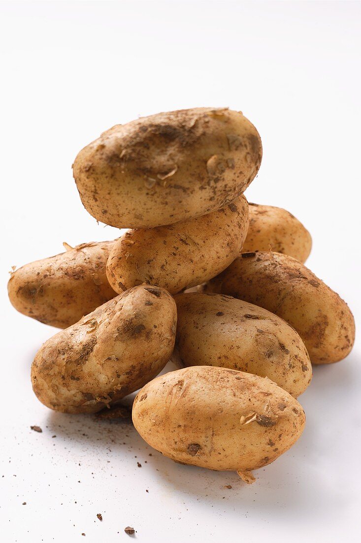 Several potatoes with soil