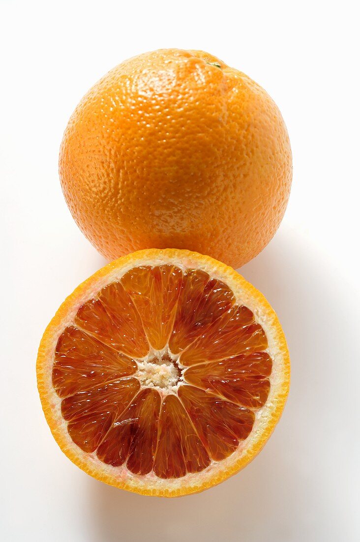 A whole and a half of a blood orange