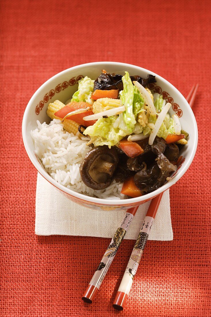 Vegetables and mushrooms cooked in wok on rice (Asia)