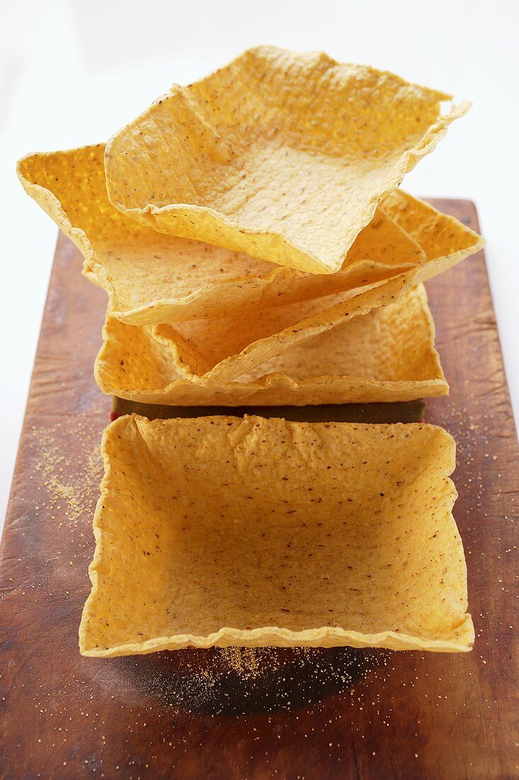 Square taco shells on chopping board