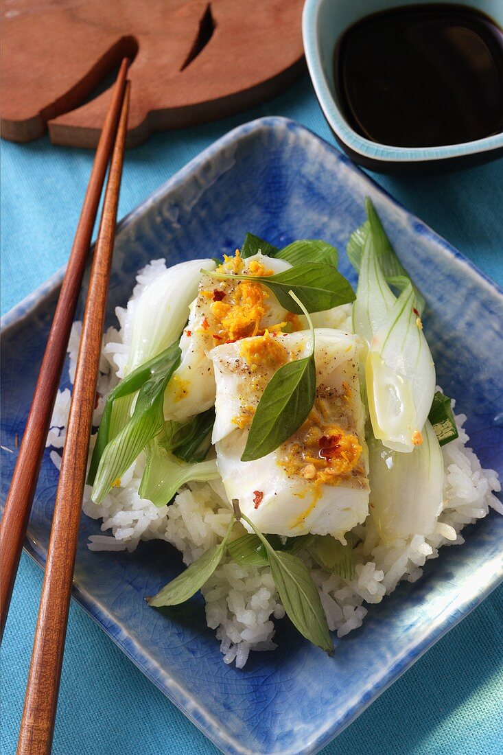 Cod with spring onions and orange sauce on rice