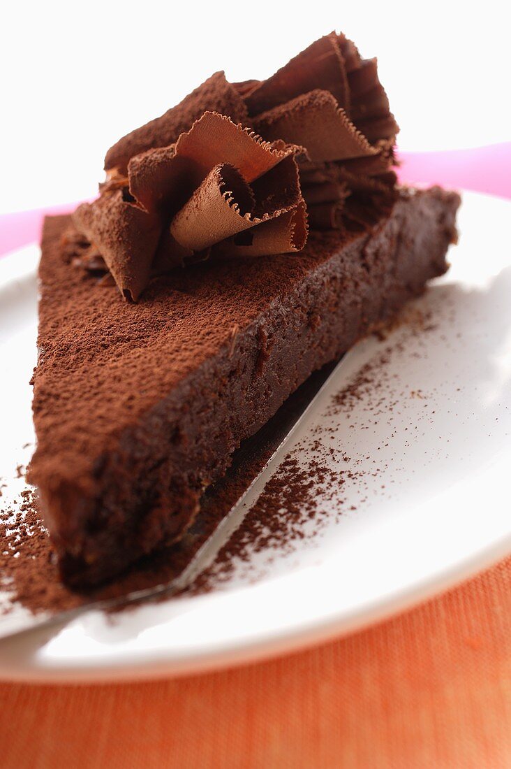 Piece of chocolate cake with chocolate curls