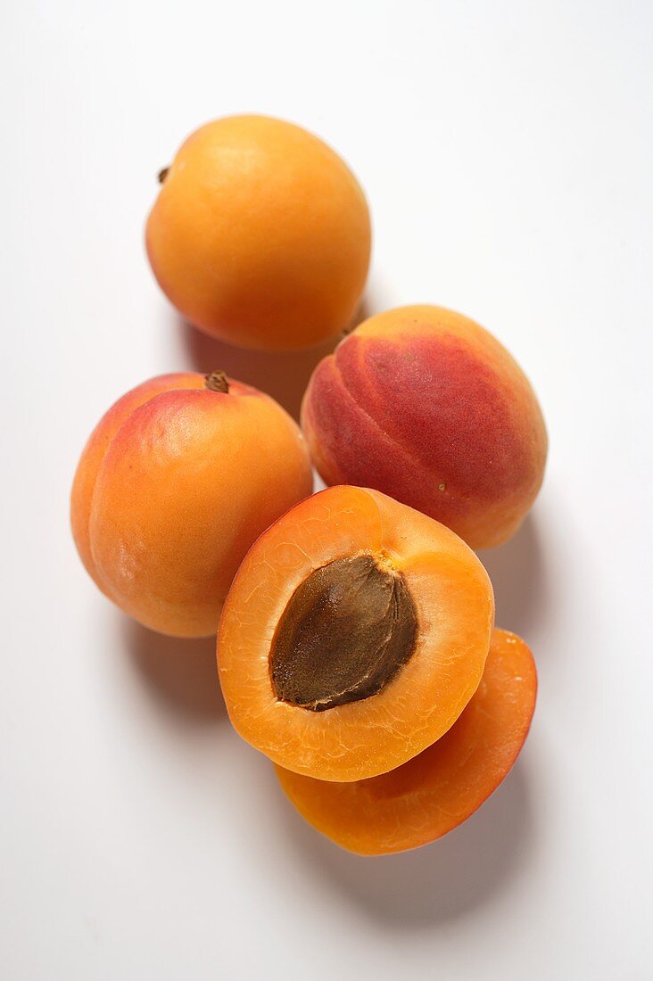 Four apricots, one halved