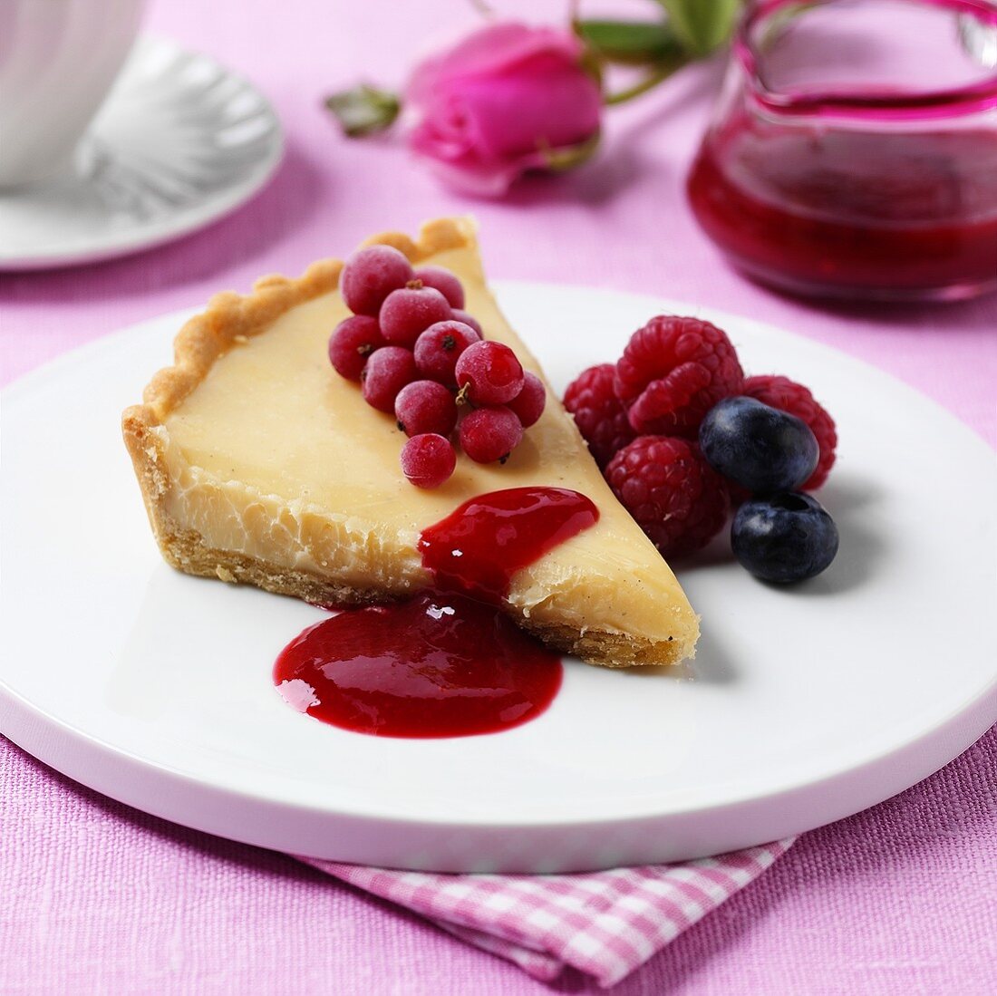White chocolate tart with berries and fruit sauce
