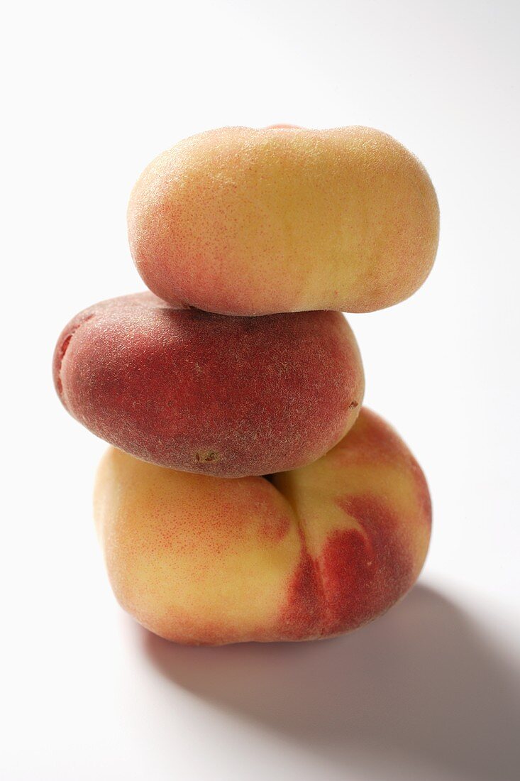 Three peaches (old variety), in a pile