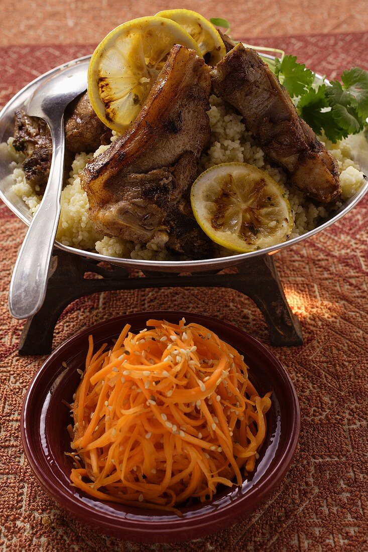 Lamb cutlets with couscous; carrot salad with sesame