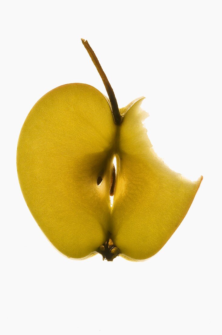 Slice of apple with stalk, a bite taken