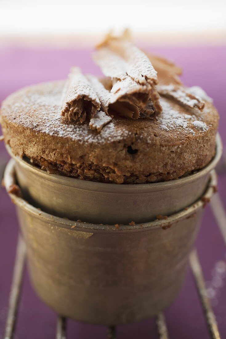 Chocolate soufflé with chocolate curls and icing sugar