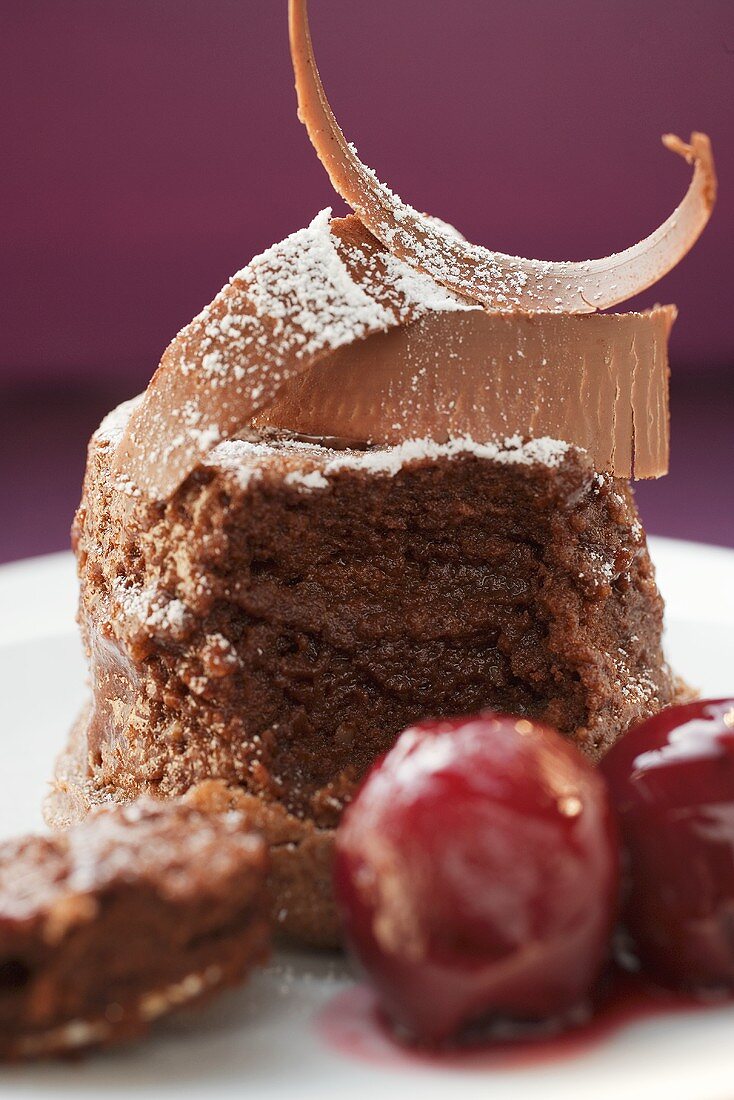 Chocolate soufflé with chocolate curls and cherries
