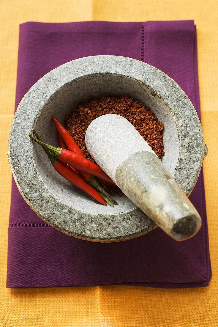 Chili peppers and chili powder in mortar