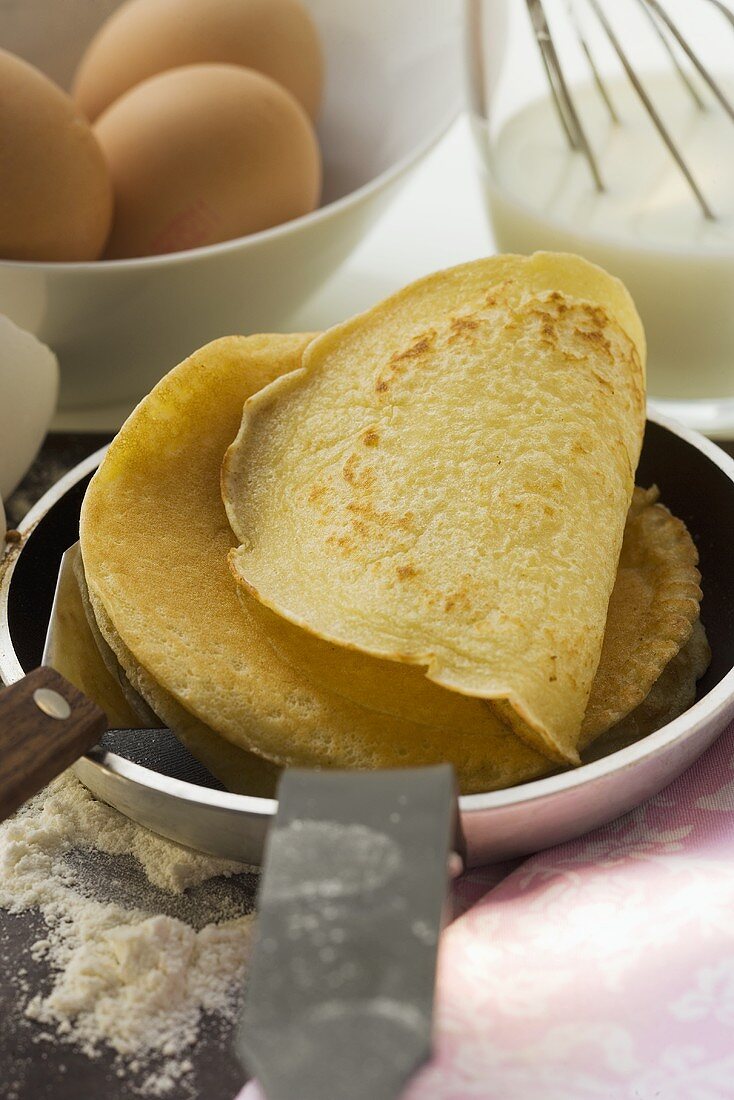 Piling up pancakes in frying pan