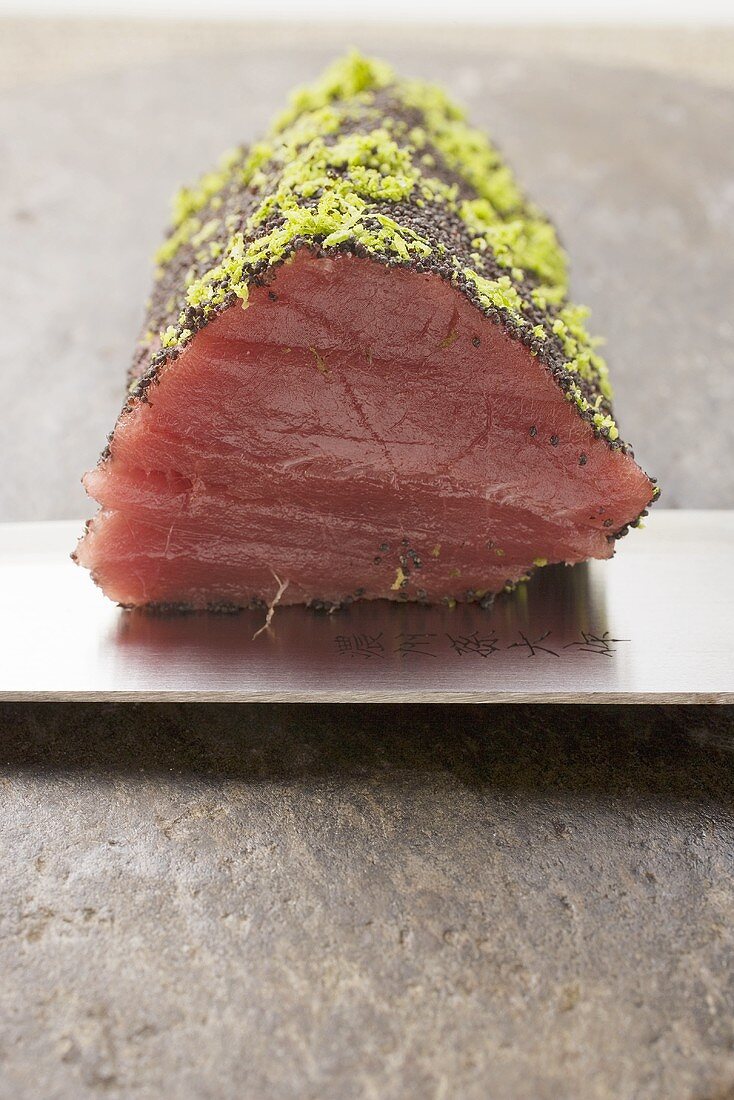 Raw tuna fillet with poppy seeds and lime zest