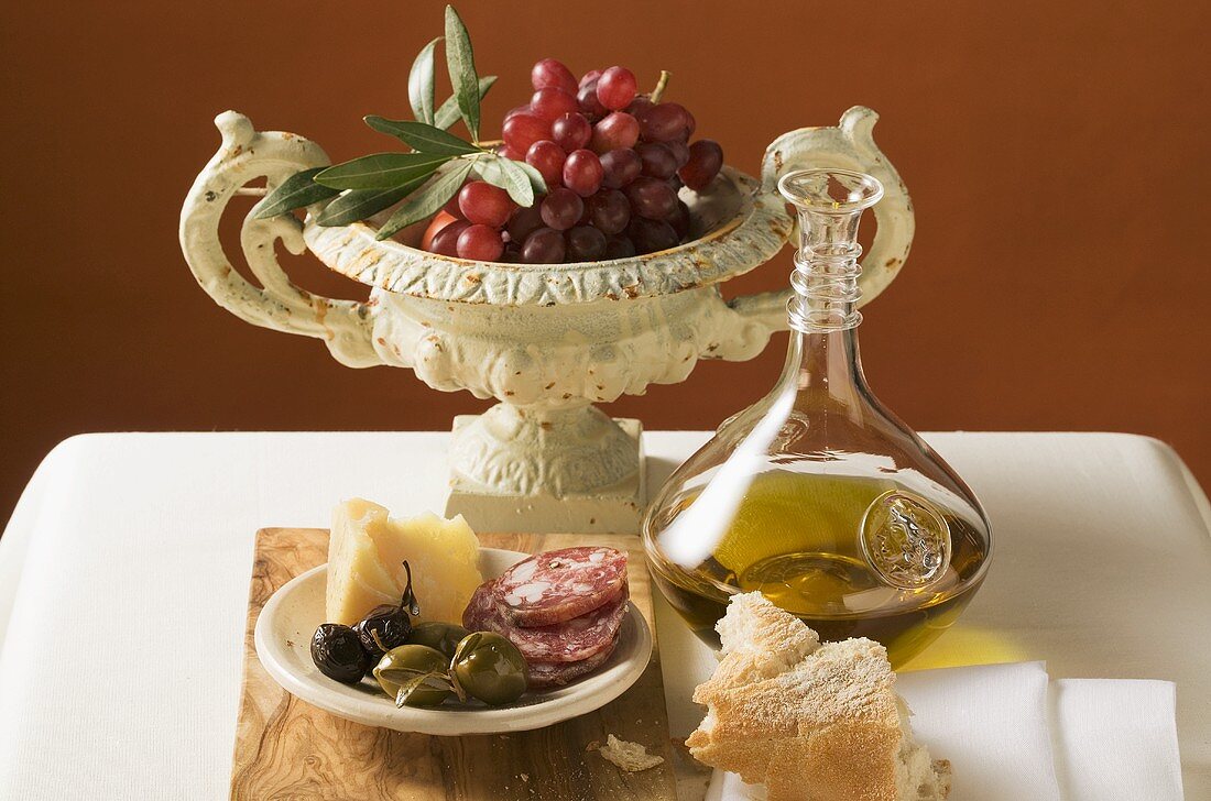 Olives, sausage, Parmesan, bread, olive oil and red grapes