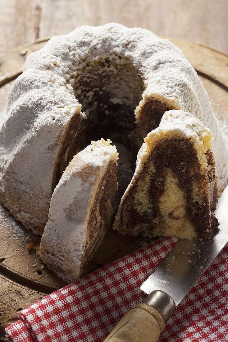 Marbled gugelhupf with icing sugar, pieces cut