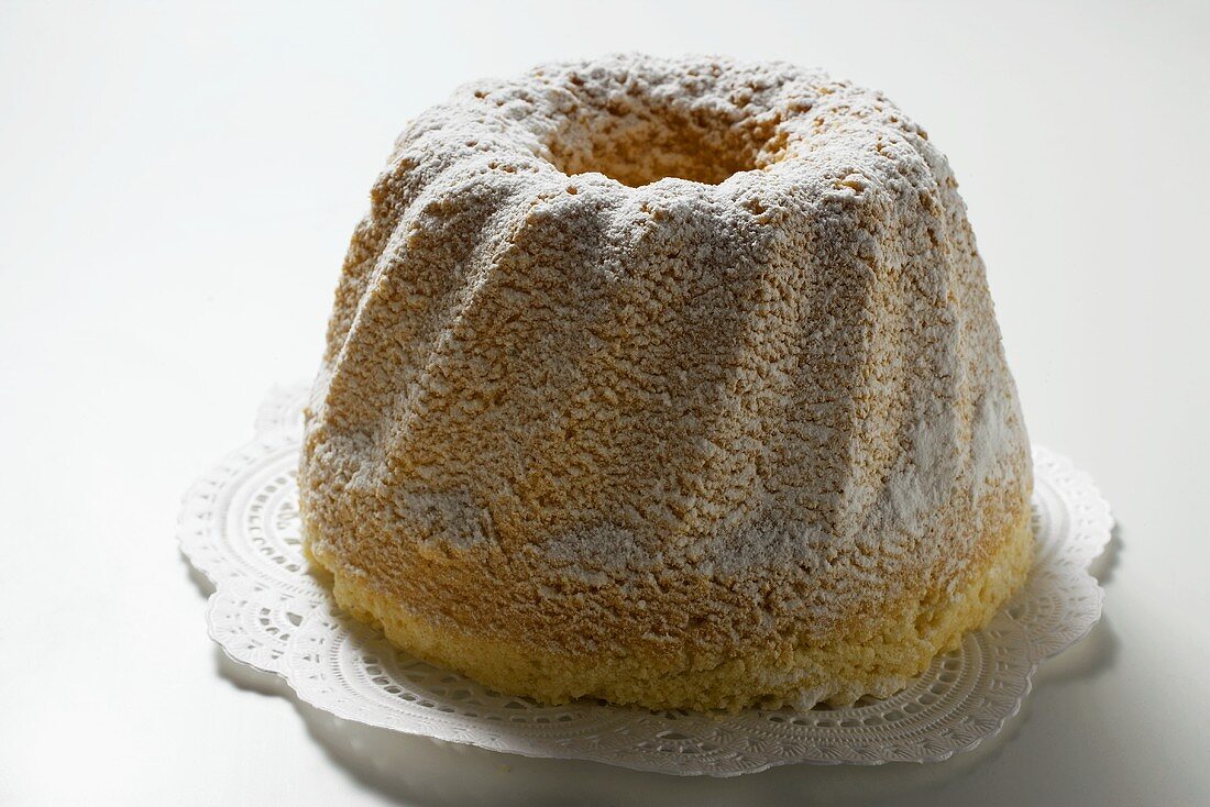 Ring cake with icing sugar on doily