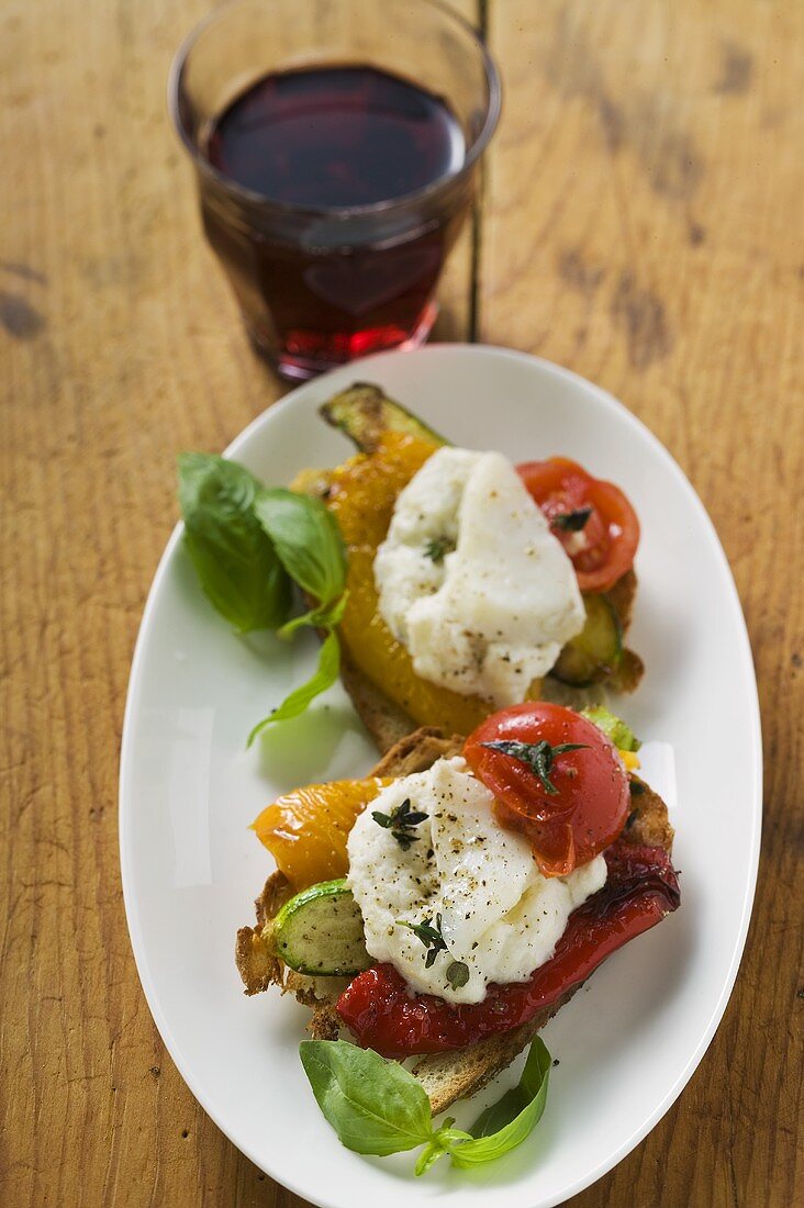 Antipasti with stockfish and glass of red wine (Italy)