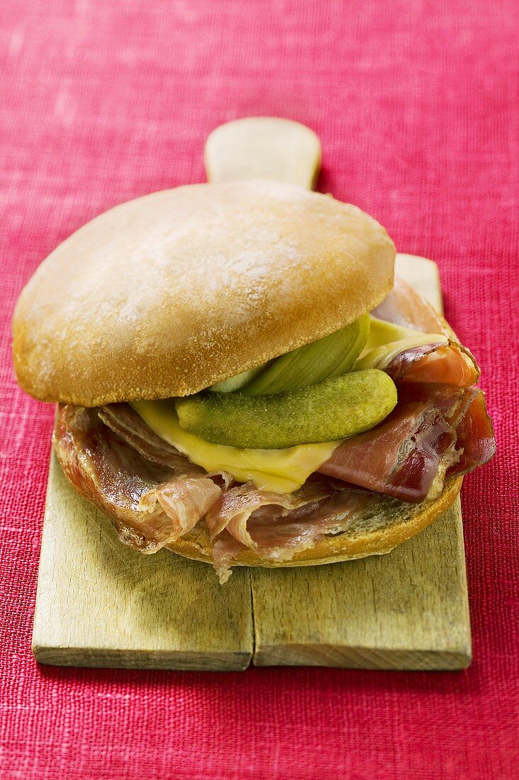 Bread roll with raw ham, cheese and gherkins