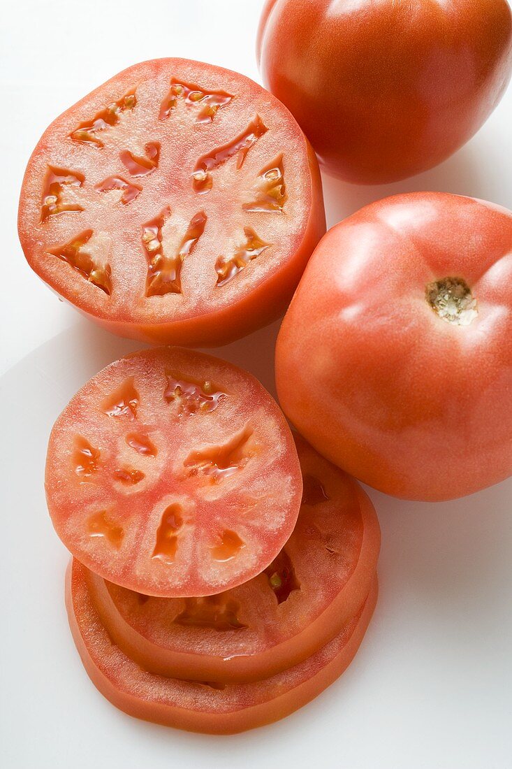 Tomatoes, whole, halved and slices