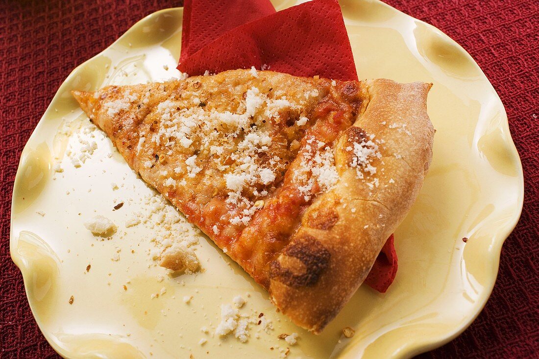 Piece of Pizza Margherita, sprinkled with Parmesan