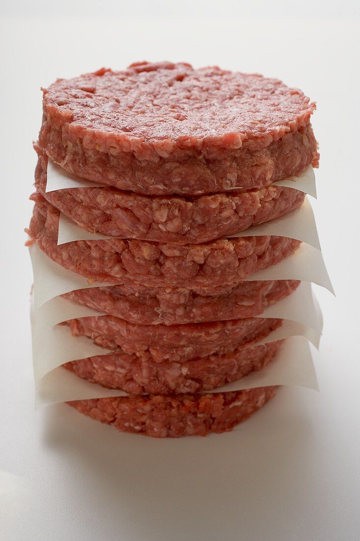 Raw burgers for hamburgers, in a pile