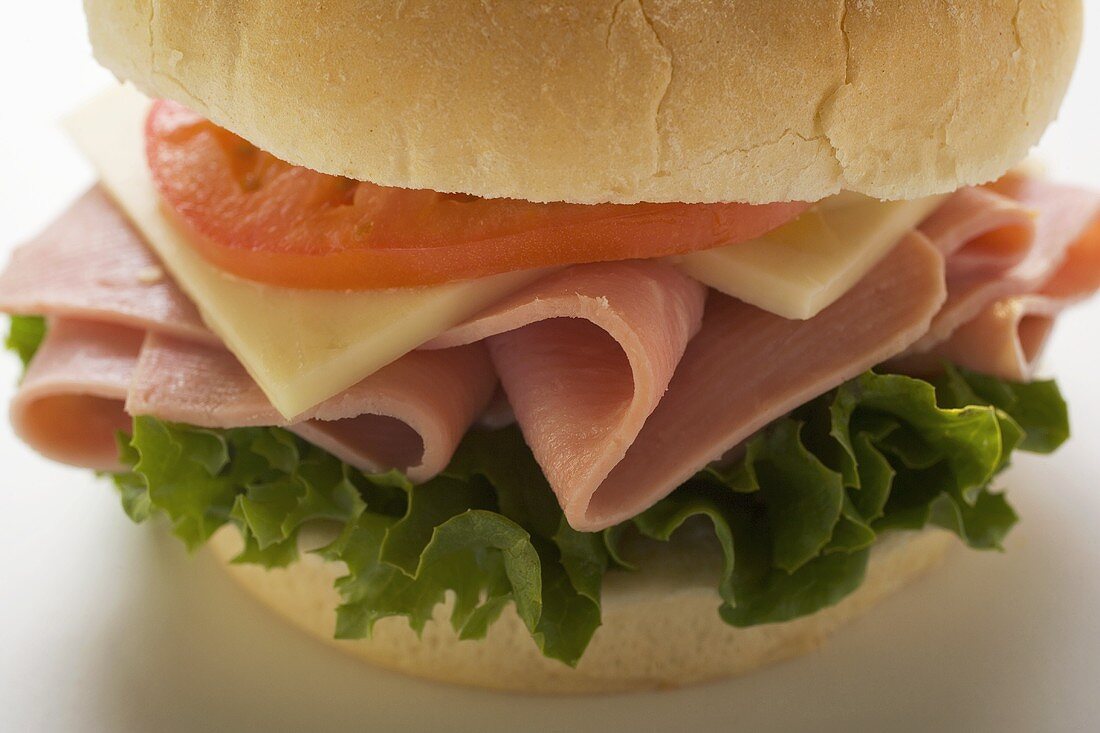 Ham, cheese and tomato in kaiser roll