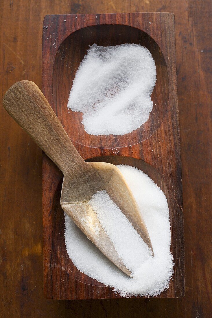 Salt in wooden bowl with scoop