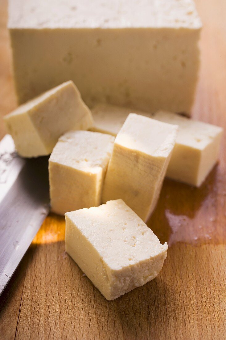 Block of tofu, diced tofu and Asian knife