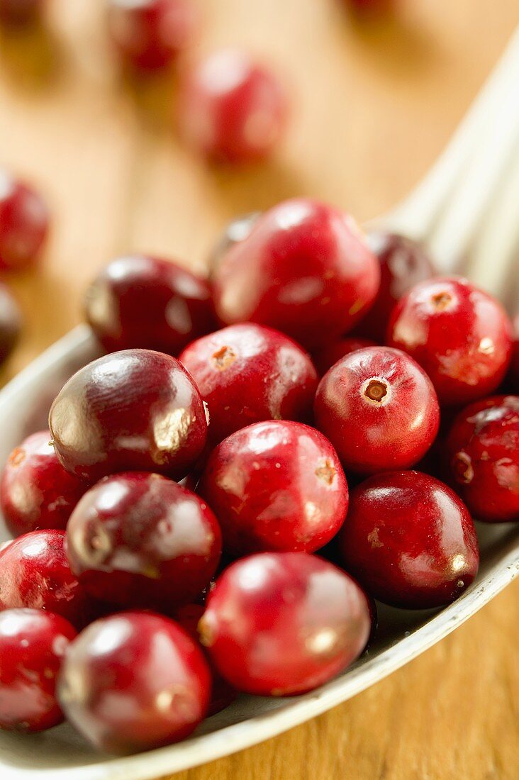 Several cranberries on spoon