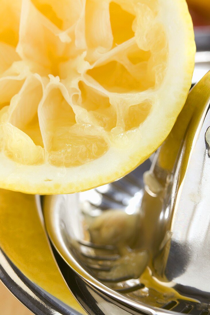 Lemon with lemon squeezer