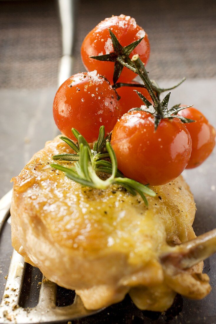 Fried chicken breast with cherry tomatoes on spatula