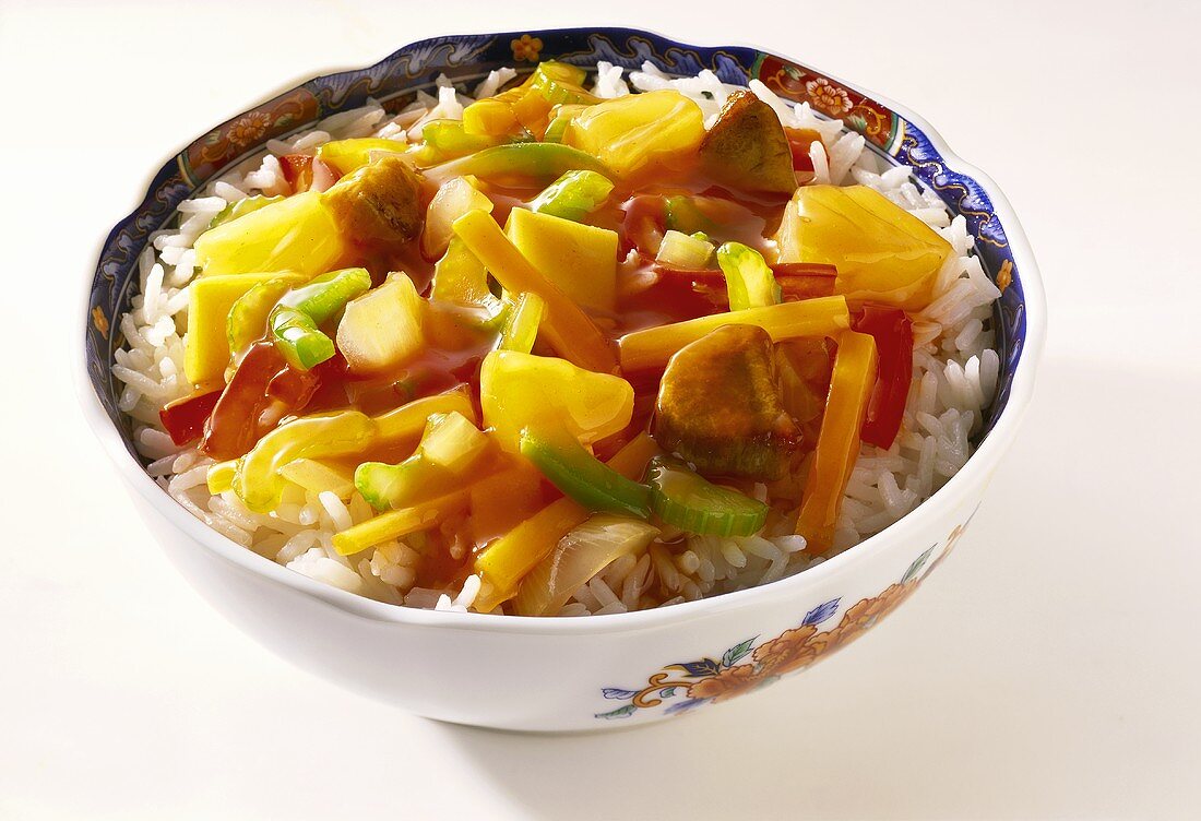 Sweet and sour meat and vegetable stir-fry on rice